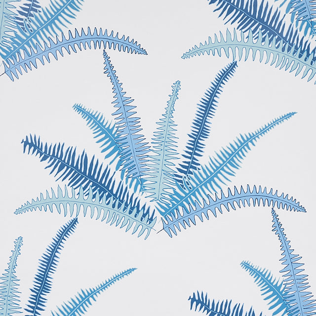 Canyon Ferns Lagoon wallpaper by Schumacher, featuring large-scale blue fern fronds in a botanical pattern, styled in a modern interior.