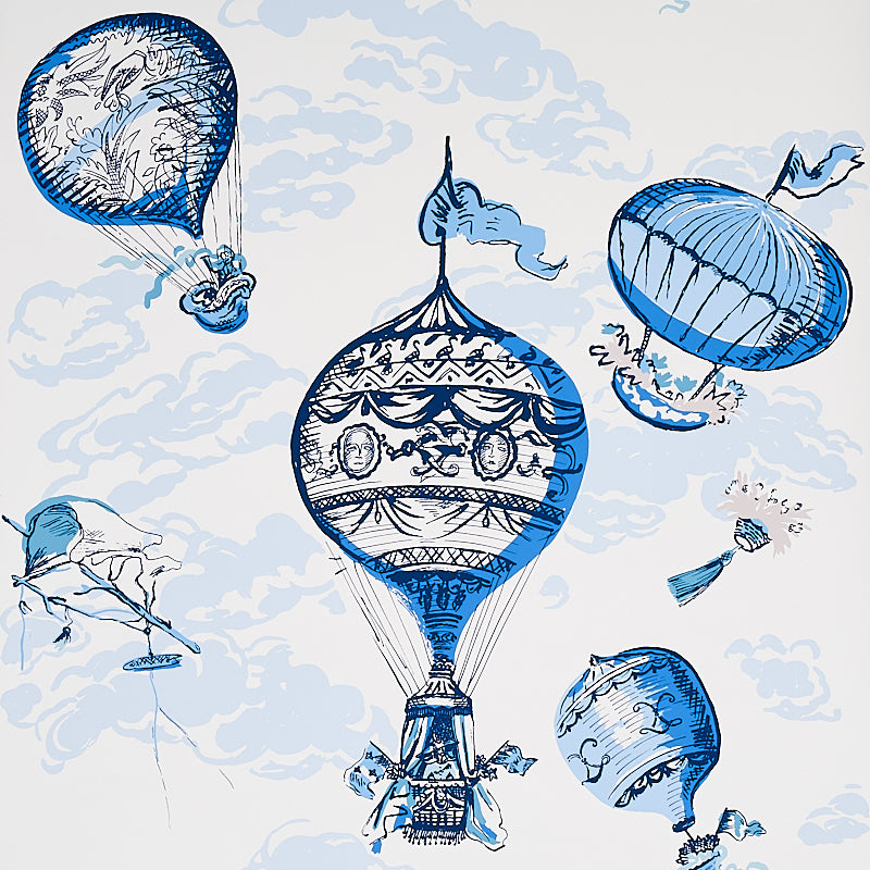 Blue and white wallpaper featuring ornate, painterly hot-air balloons floating among clouds, from Schumacher's Flight Of Fancy collection.
