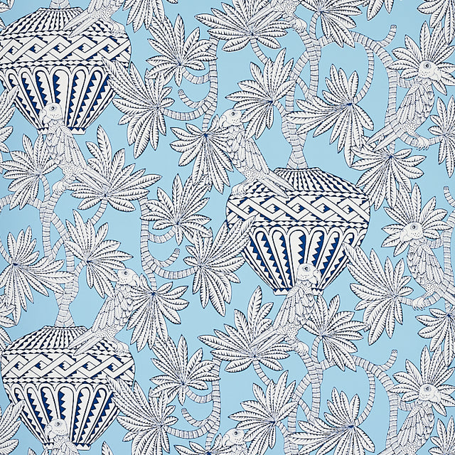 Santarem Sky wallpaper by Schumacher featuring blue and white tropical foliage, parrots, and decorative vases in a whimsical pattern.