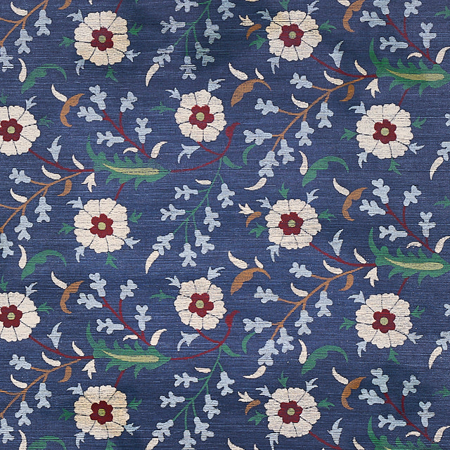 Floralia Sisal Indigo wallpaper by Schumacher, a scrolling botanical floral design on a textured sisal ground.