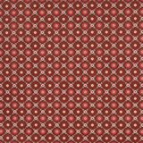 Larissa wallpaper in burgundy with intricate lattice and folkloric floral design, styled in a traditional interior setting.