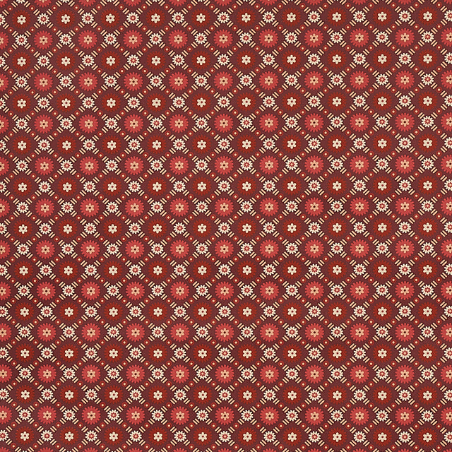 Larissa wallpaper in burgundy with intricate lattice and folkloric floral design, styled in a traditional interior setting.