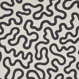 RILEY Soft Black abstract squiggle wallpaper by Schumacher, shown in a modern interior setting.