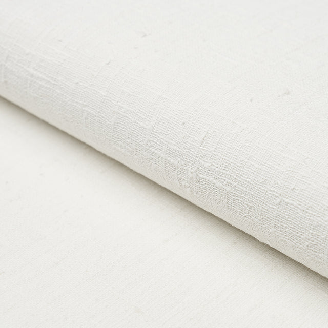 Linen Bark in white, a textured, handwoven linen wallcovering by Schumacher, shown in close-up and styled interior settings.