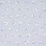 Taylor Blues wallpaper by Schumacher featuring offset-printed bursts of tiny blue dots over a field of larger dots, shown in a modern interior setting.