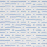 Abstract Ikat Sky wallpaper by Schumacher, featuring a rhythmic broken-stripe pattern in blue on white, shown in a modern living room setting.