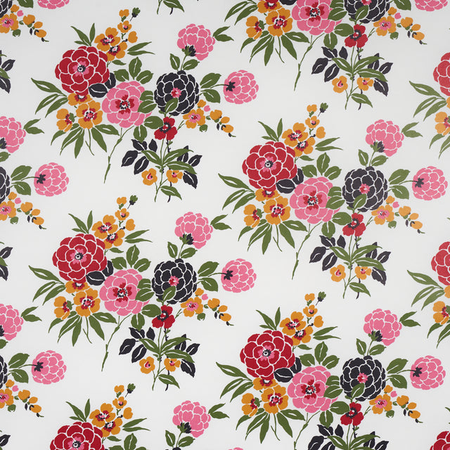 Valentina Floral wallpaper in multi on white, featuring vibrant stylized blossoms and green foliage on a white background.