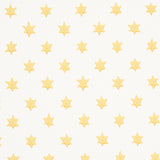 Astral yellow wallpaper by Schumacher featuring small six-pointed stars in a repeating pattern, designed by Hobe Erwin.