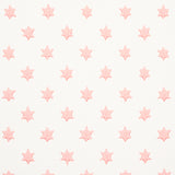 Astral pink wallpaper by Schumacher featuring small six-pointed stars in neat offset rows, designed by Hobe Erwin.