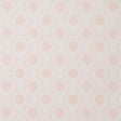 Hive Bloom blush geometric floral wallpaper by Schumacher, designed by Hobe Erwin, shown in a styled bedroom setting.