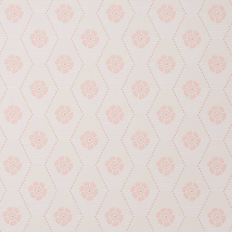 Hive Bloom blush geometric floral wallpaper by Schumacher, designed by Hobe Erwin, shown in a styled bedroom setting.