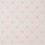 Hive Bloom blush geometric floral wallpaper by Schumacher, designed by Hobe Erwin, shown in a styled bedroom setting.