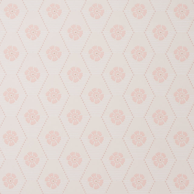 Hive Bloom blush geometric floral wallpaper by Schumacher, designed by Hobe Erwin, shown in a styled bedroom setting.