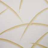 Deco Palms gold wallpaper with stylized palm fronds in a modern Art Deco style, shown in a sophisticated living room setting.