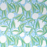 Rubus Delft painterly floral wallpaper with stylized leaves and large graphic globes of flowers by Schumacher