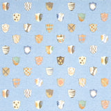 Heraldic wallpaper in Oxford Blue by Happy Menocal for Schumacher, featuring whimsical colorful shields on a mottled blue background.