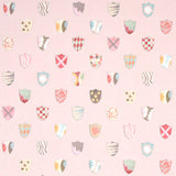 Heraldic wallpaper in pink by Happy Menocal for Schumacher, featuring whimsical colorful shields on a mottled background.
