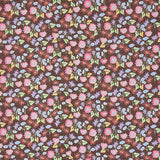 Calico by Happy Menocal for Schumacher - multicolor microfloral wallpaper in multi on brown, shown in detail and installed in a bedroom setting.