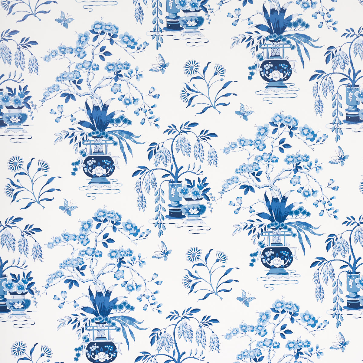 Ming Vase porcelain blue and white chinoiserie floral wallpaper by Schumacher, shown in detail and installed in a room.