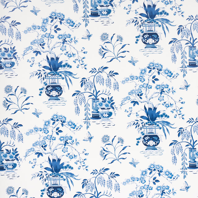 Ming Vase porcelain blue and white chinoiserie floral wallpaper by Schumacher, shown in detail and installed in a room.