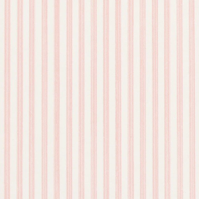 Edwin Stripe Narrow wallpaper in Petal by Schumacher, featuring narrow pink stripes on a white background, shown in a bright, classic interior setting.
