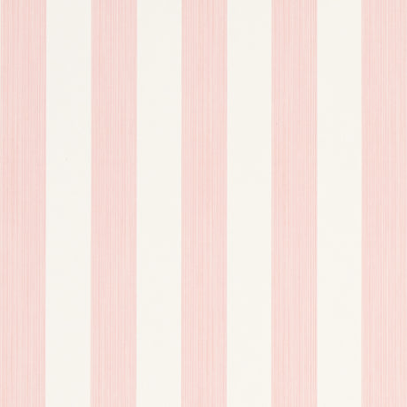 Edwin Stripe Medium wallpaper in Petal by Schumacher, classic pink and white vertical stripes, shown in a bright window nook.