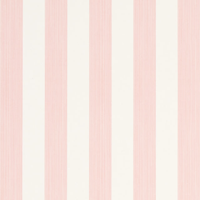 Edwin Stripe Medium wallpaper in Petal by Schumacher, classic pink and white vertical stripes, shown in a bright window nook.
