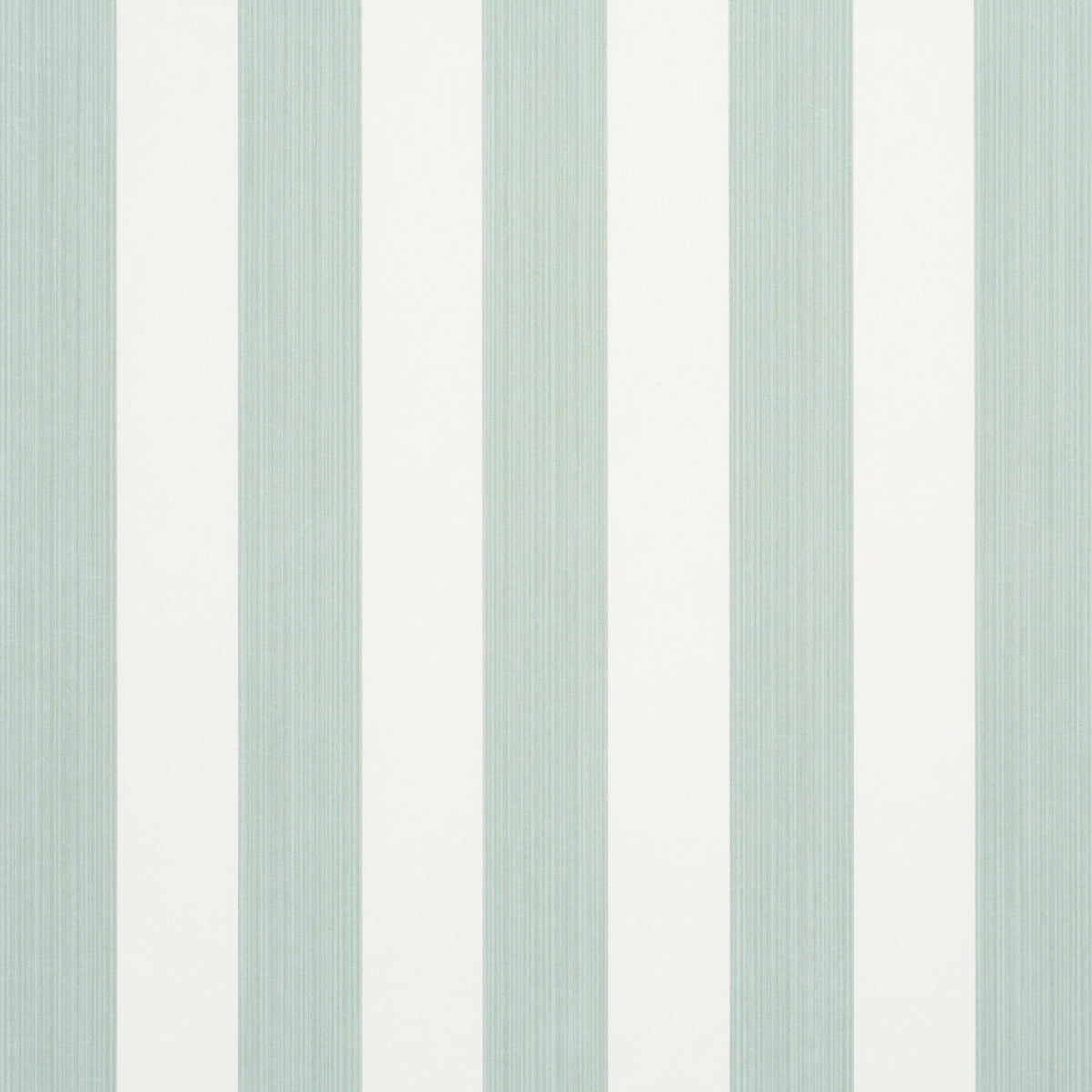 Edwin Stripe Medium wallpaper in Eucalyptus by Schumacher, featuring medium-width green and white vertical stripes, shown in a styled bedroom setting.