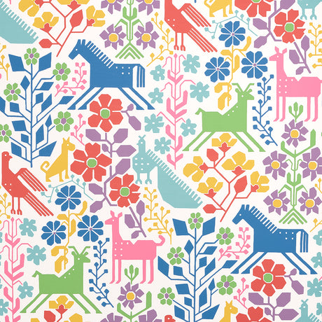 LUPITA vibrant multi-color wallpaper with whimsical animals and floral motifs by Schumacher, shown in a modern interior setting.