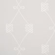 Nicolette wallpaper in white on grey, featuring a swirling trellis motif by Schumacher.