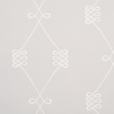Nicolette wallpaper in white on grey, featuring a swirling trellis motif by Schumacher.