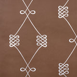 Nicolette wallpaper in silver on brown, featuring a swirling trellis motif by Schumacher.