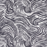 SHIO Carbon wallpaper by Schumacher featuring a dynamic, abstract brushstroke pattern in black and white, shown in a modern bedroom setting.