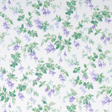 Garden Gate wallpaper in violet with a painterly floral and leafy design, shown in a styled interior and close-up views.