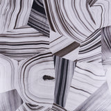 Black and white abstract agate slice patterned wallpaper by Schumacher, designed by Miles Redd, shown in a styled interior and close-up views.