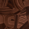 Miles Redd Agate Slice Tigers Eye wallpaper with abstract high-gloss stone pattern in rich brown tones, shown in detail and installed in a modern living room.