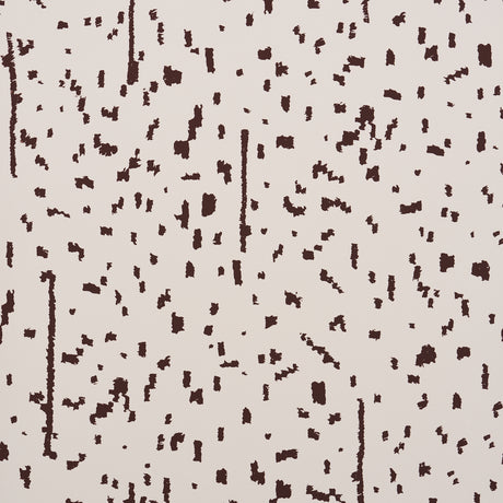 Bespotted brown abstract spotted wallpaper by Schumacher, shown in detail and installed in a modern living room.