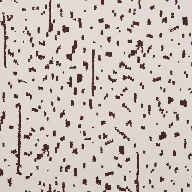 Bespotted brown abstract spotted wallpaper by Schumacher, shown in detail and installed in a modern living room.