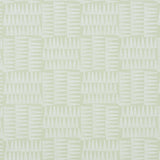 Charlie green wallpaper by Schumacher featuring a dense forest of pennant stripes in a small-scale pattern, shown in a styled bedroom setting.
