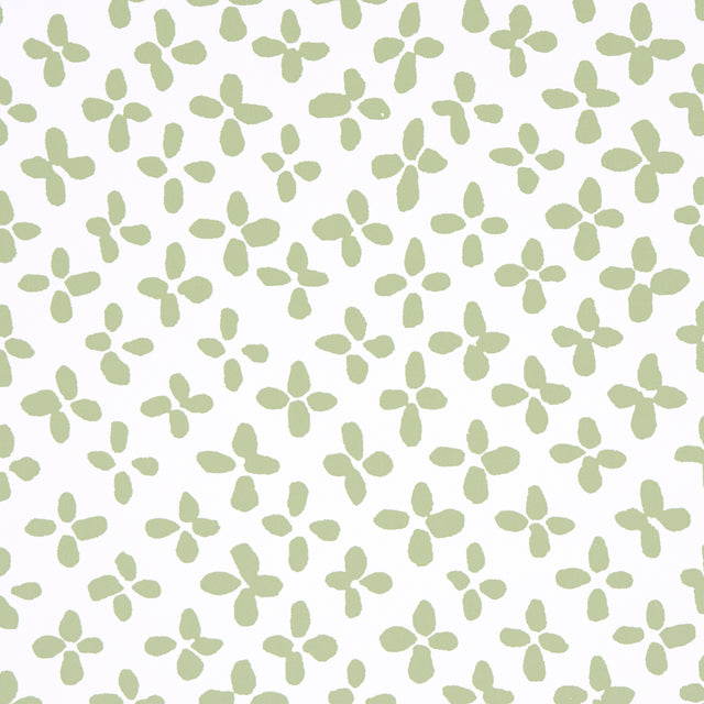Emerson green-on-ivory small-scale quatrefoil print wallpaper by Schumacher, shown in close-up, roll, and room setting.