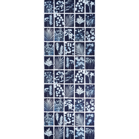 Cyanotype Panel wallpaper in indigo featuring botanical silhouettes in a grid pattern by Schumacher.