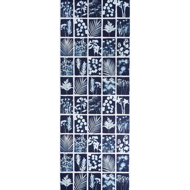 Cyanotype Panel wallpaper in indigo featuring botanical silhouettes in a grid pattern by Schumacher.