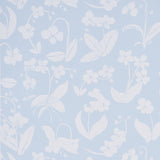 Orchids Have Dreams wallpaper in sky blue by Hera Ford for Schumacher, featuring large-scale painterly orchid silhouettes.
