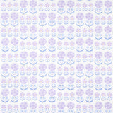 Anjuna Floral wallpaper in lilac by Schumacher, inspired by antique Suzani textiles with stylized floral motifs in purple and blue tones.