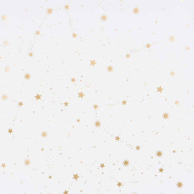 Scattered Stars wallpaper in ivory by Schumacher, featuring a constellation of metallic gold stars on a matte ivory background.