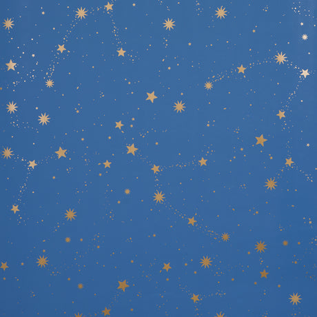 Scattered Stars wallpaper in Night by Marie-Chantal for Schumacher, featuring a constellation of metallic gold stars on a deep blue background.