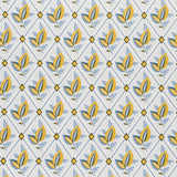 Basile Trellis wallpaper in yellow and blue, a leafy lattice geometric print by Schumacher, shown in a styled bathroom interior.
