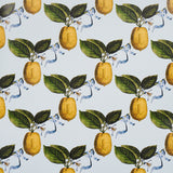 Le Citron Sky wallpaper by Johnson Hartig for Schumacher, featuring a whimsical lemon and ribbon pattern on a light blue background.