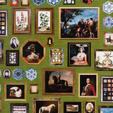 Le Grand Tour wallpaper in English Green by Johnson Hartig for Schumacher, featuring an eclectic gallery of antique paintings and collectibles on a green background.