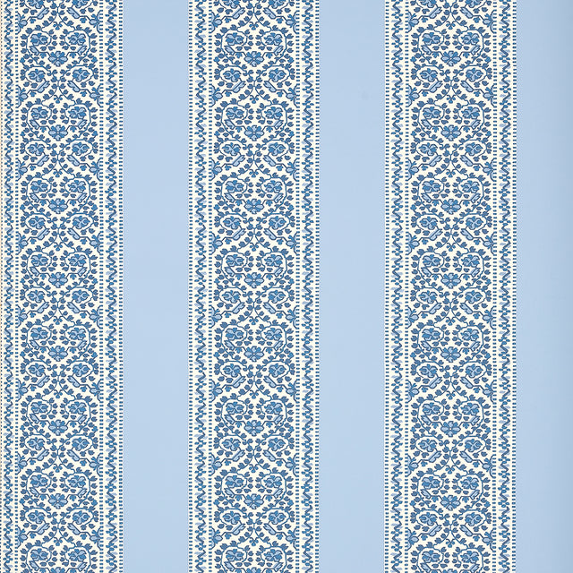 JASMINE Indigo wallpaper by Schumacher featuring a blue and white floral stripe pattern, shown in a styled interior and product detail shots.